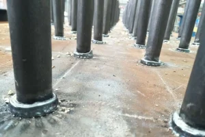 Close-up view of a completed shear stud weld, illustrating the clean, strong, and consistent fusion line of the structural shear connector to the steel base plate.