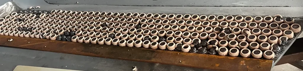 Bulk stock of ZOCMachinery Ceramic Ferrules for Wear Studs in excavator buckets.