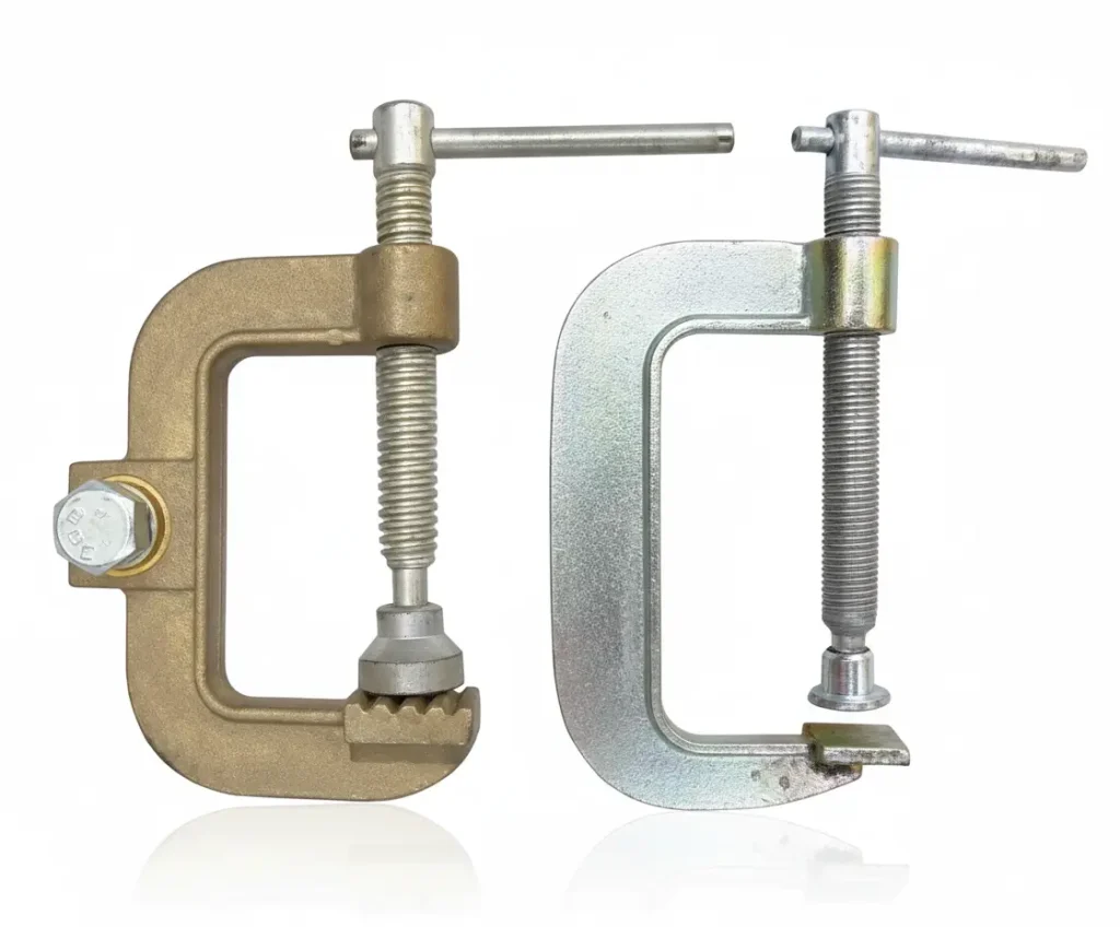 Close-up of a high-conductivity solid copper grounding clamp attached to a steel workpiece.