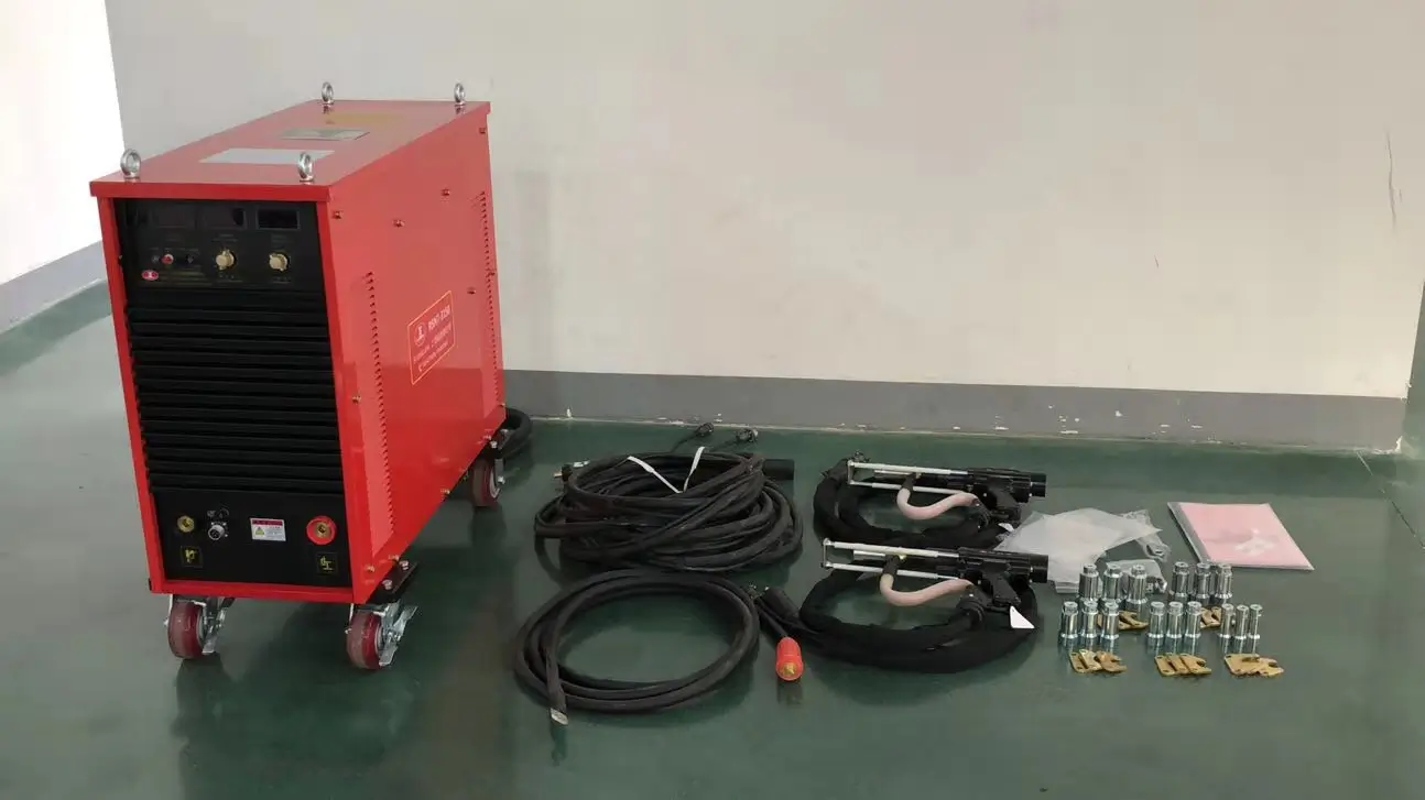 Complete set of heavy-duty drawn arc stud welder including power source, welding cables, two hand guns, and assorted chucks for industrial construction.
