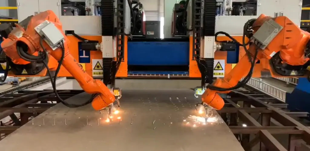 Automated robotic shear stud welding machine with dual robot arms for high-speed industrial production.