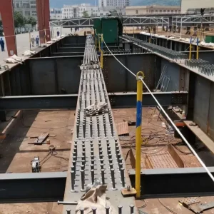 Close-up of headed shear studs welded on a steel I-beam for composite structure bridge construction.